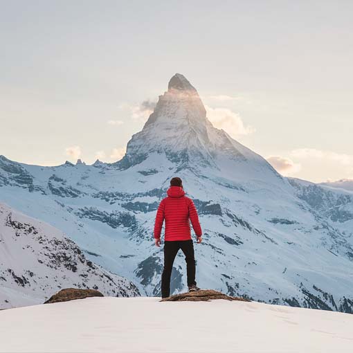 Man scaling mountain.