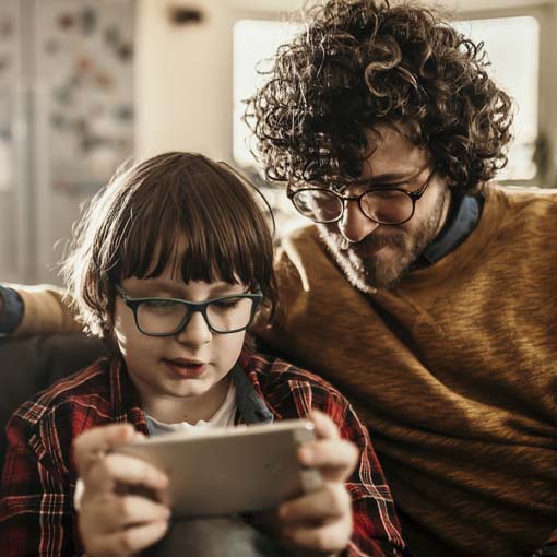 Father and son viewing smartphone.