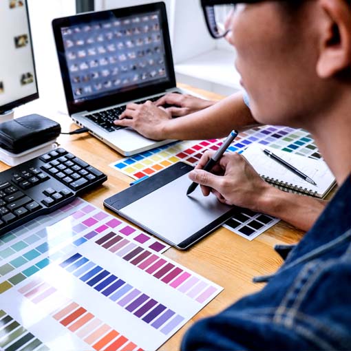 Graphic Designer studying sketches.