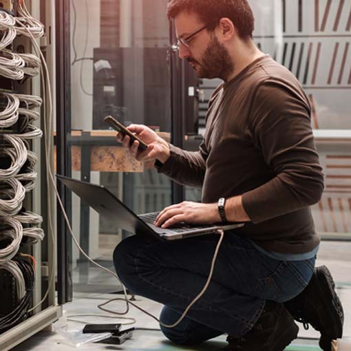 A Systems Engineer working on a server rack.