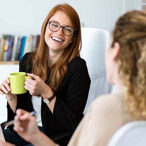 Two women drinking coffee